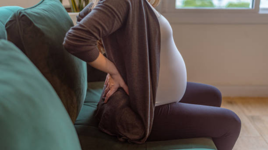 pregnant woman suffering from joint and muscle pain