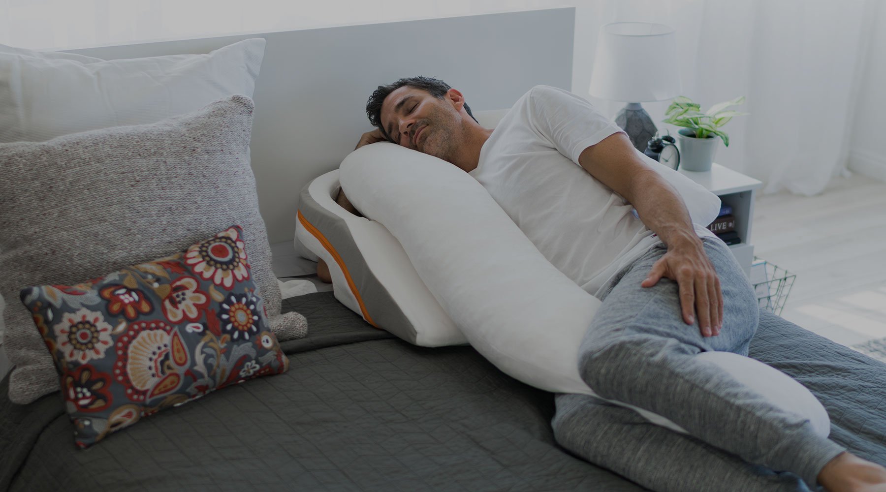 man sleeping on bed with medcline system